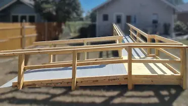 Home Accessibility Program — wheelchair ramp with handrails leading to a home